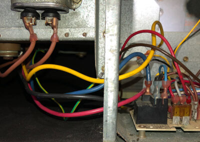 Clean and well-organized electrical wires inside a HVAC system, with new connectors and properly arranged wiring.