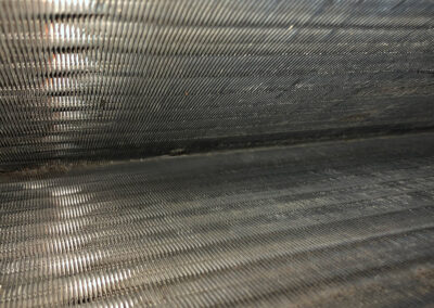 An HVAC coil thoroughly cleaned, showing the metal surface free of debris and buildup, ensuring optimal airflow and cleanliness.