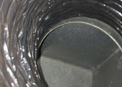 A cleaned HVAC evaporator coil, with all debris and dirt removed, showing restored metal shine.