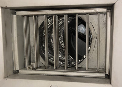 Air vent cleaned by American Clean Air, now free from dirt and debris, with visibly clean metal slats and a polished surface.