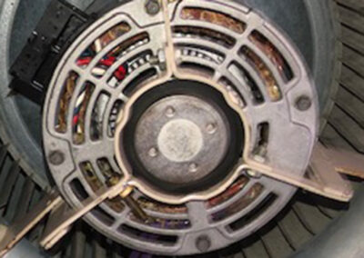 A cleaned and restored motor fan in an HVAC system, free of dust and rust, showing improved condition.