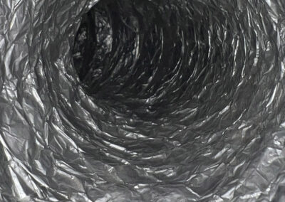 A clean and clear dryer vent, showing smooth and unobstructed airflow, free of any lint or dust buildup.