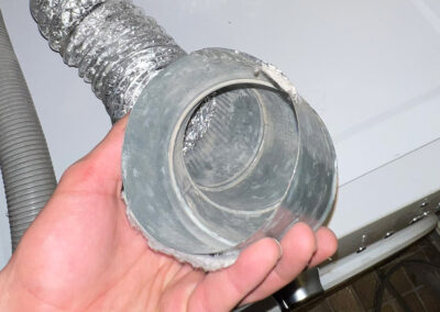 A cleaned dryer vent hose connection showing the clean, clear opening after lint removal by American Clean Air.