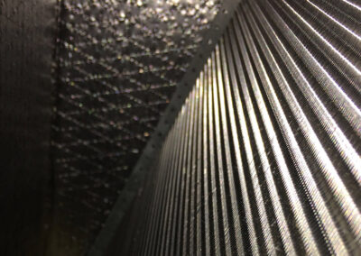 A cleaned HVAC coil, now shiny and clear of any dust, dirt, or debris, revealing the metal fins and intricate patterns.