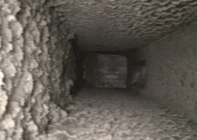 Close-up view of a dryer vent filled with heavy lint buildup.